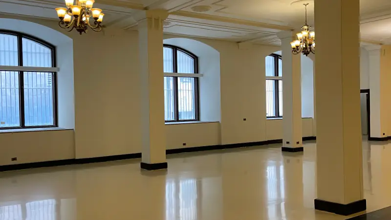 Glossy decorative floor at the Théâtre Saint-James, a columned hall with chandeliers