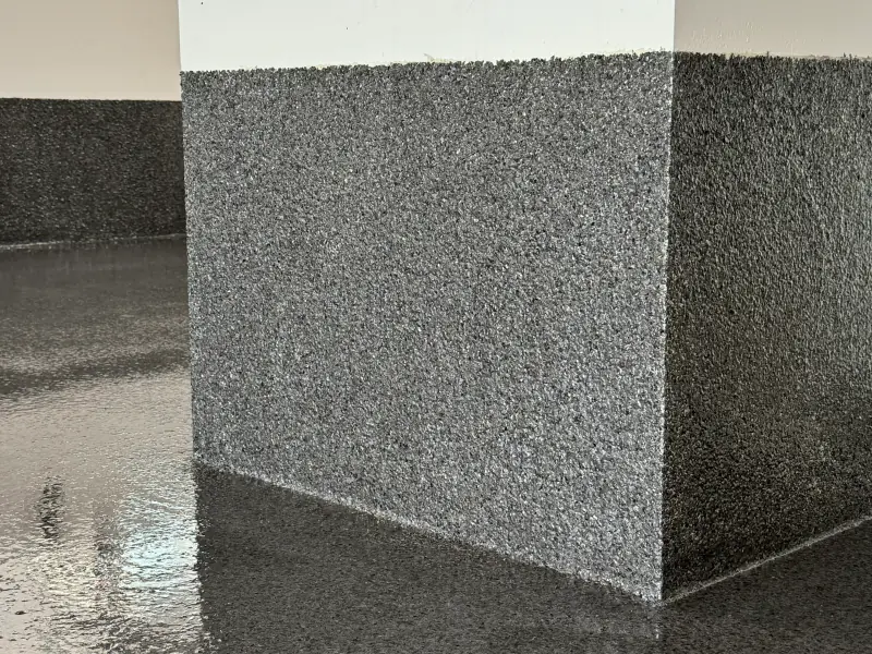 Detail of a pillar and cove base in flake epoxy, carried up the wall