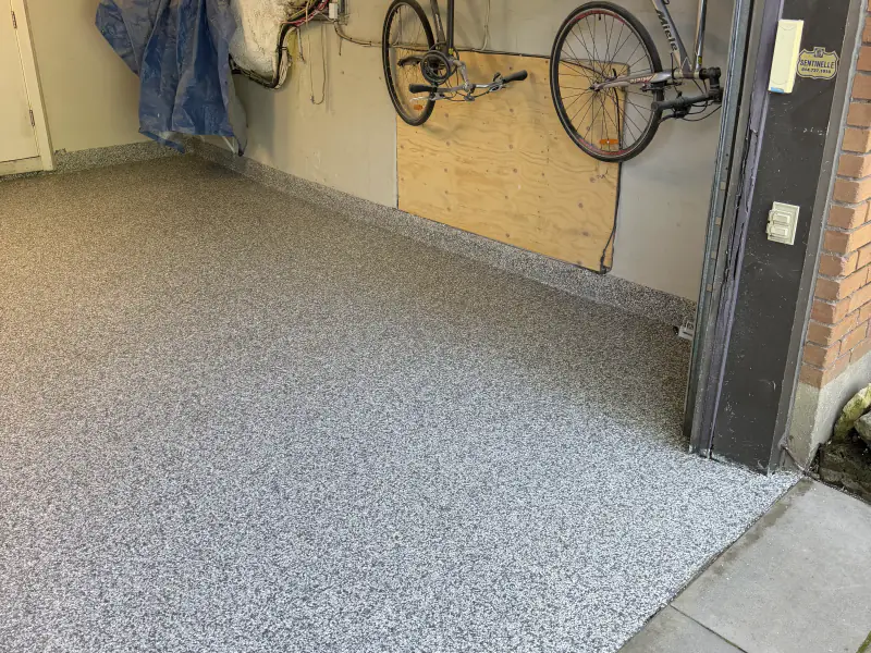 Residential garage finished in grey flake epoxy