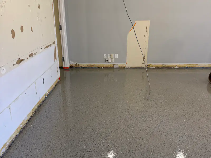 Finished glossy flake floor in a unit whose walls are still under construction