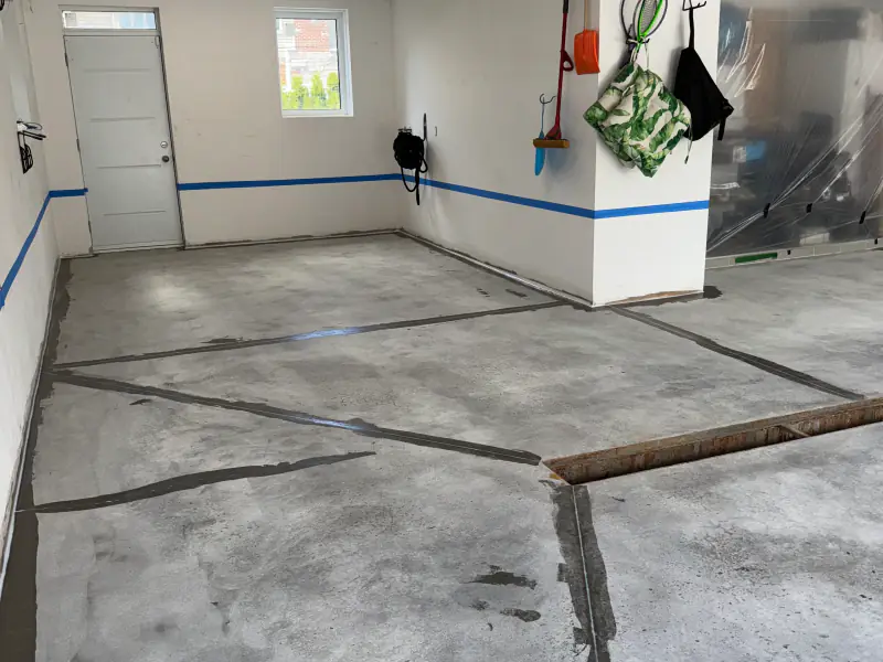 Ground garage slab with repaired cracks, before the epoxy goes on