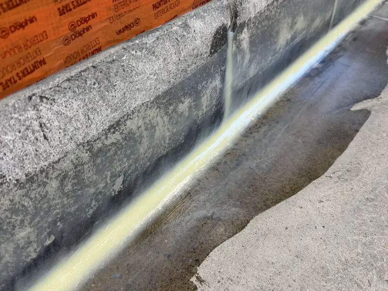 Waterproofing membrane applied at the wall-to-floor joint