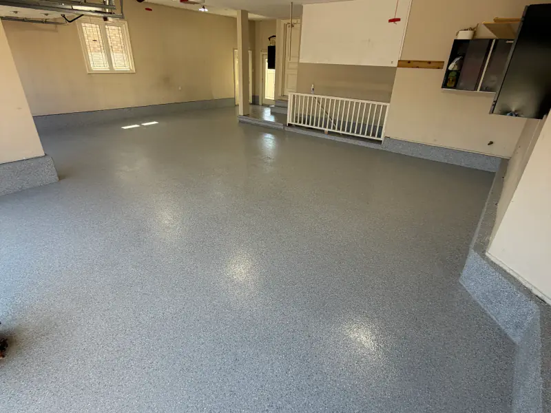 Residential garage finished in blue-grey flake epoxy
